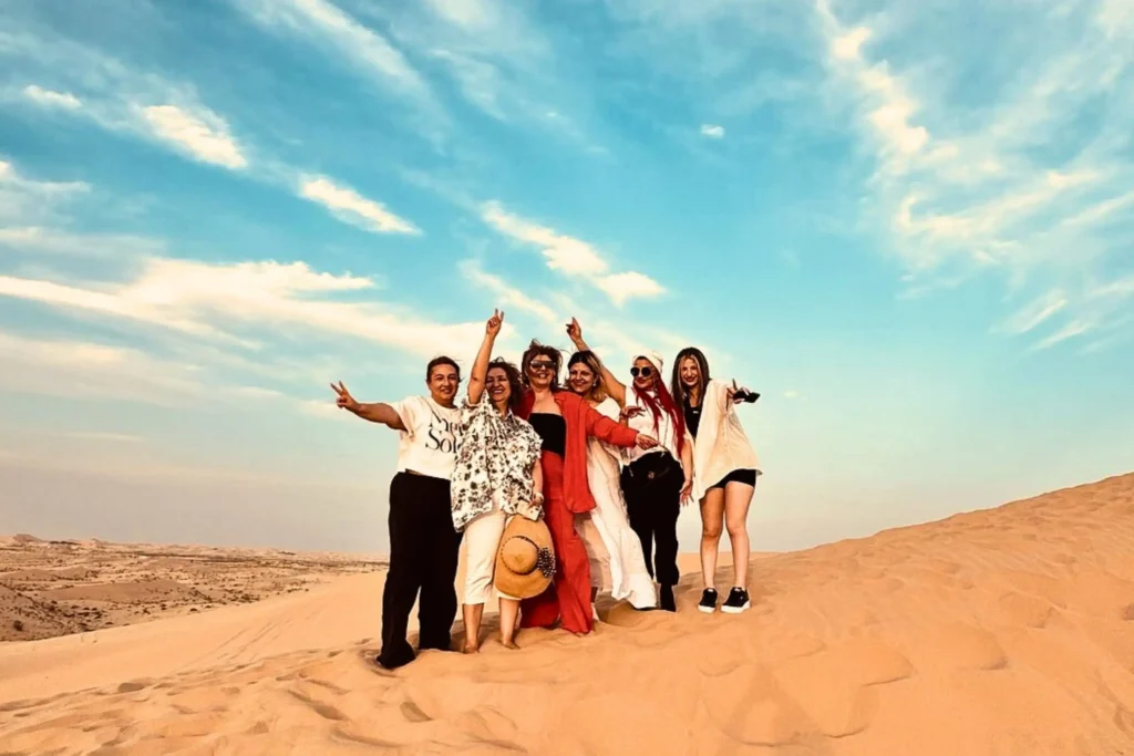 a group of female tourists enjoying a private desert safari tour abu dhabi organized by desert safari tour abu dhabi